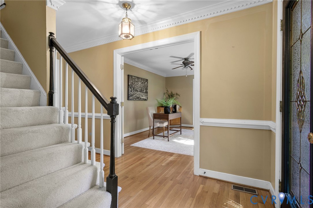 15010 Walnut Bend Road Midlothian, VA 23112 - Photo 5 of 35 a view of a hallway with wooden floor and dining room view
