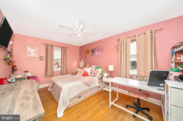a bedroom with a bed and large windows