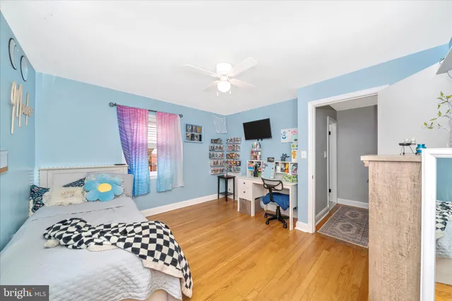 a bedroom with furniture and a wooden floor