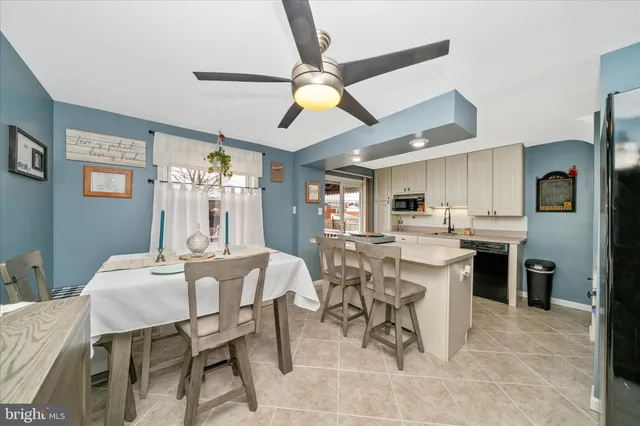 a dining room with stainless steel appliances kitchen island granite countertop furniture and a kitchen view
