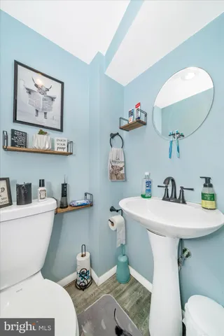 a bathroom with a sink mirror and toilet