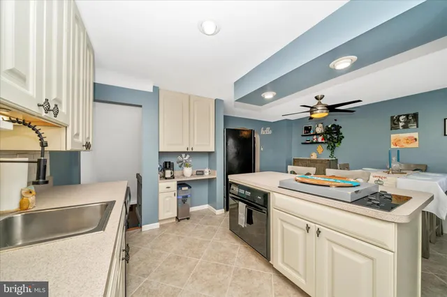 a kitchen that has a sink and a stove in it