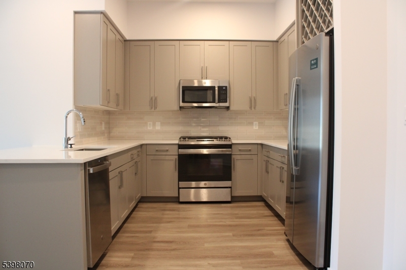 a kitchen with a sink and a stove top oven