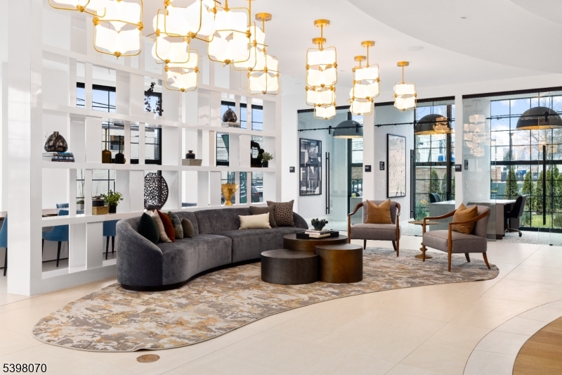 2 River Road, Unit 306 Chatham, NJ 07928 - Photo 9 of 13 a living room with furniture large windows and wooden floor