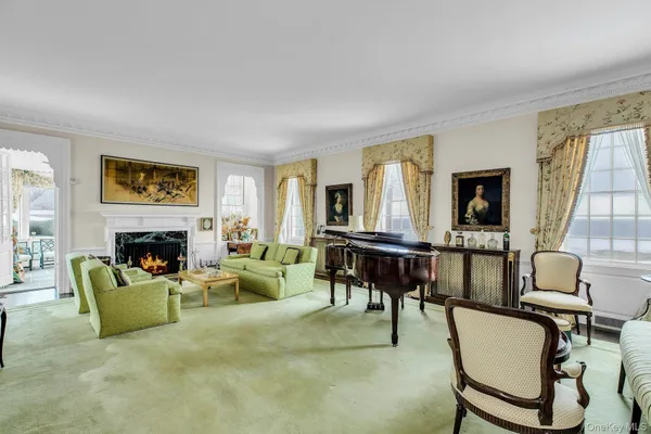 a living room with furniture and a chandelier
