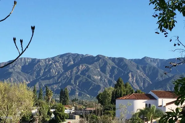a view of a house with a mountain and a forest