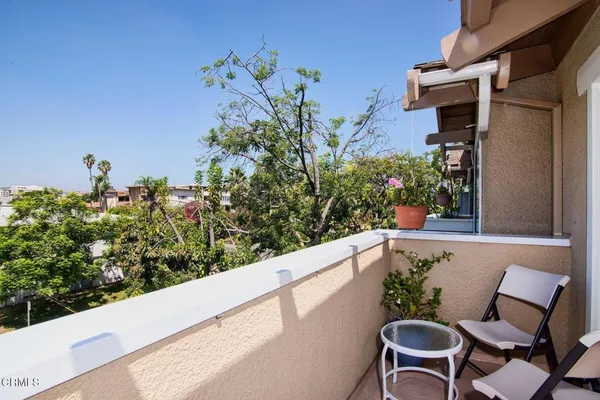 a view of a chairs and table in a back yard