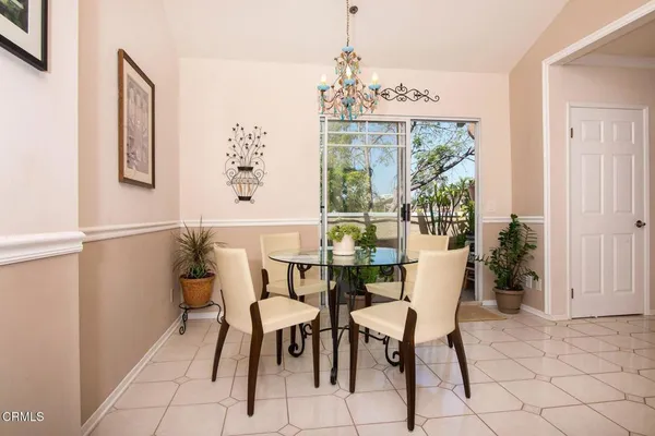 a view of a dining room with furniture and chandelier