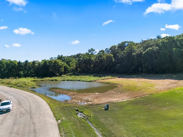 a view of a swimming pool with a yard