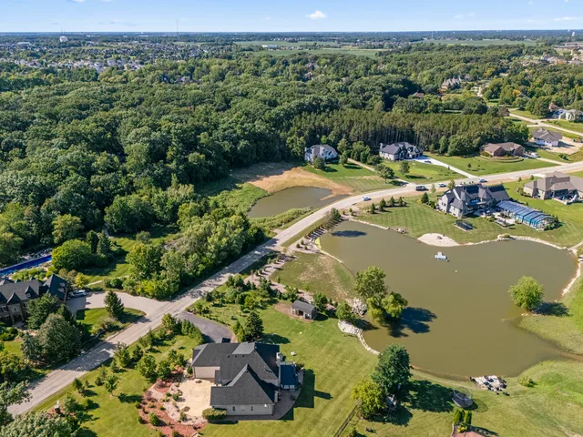 an aerial view of residential houses with outdoor space