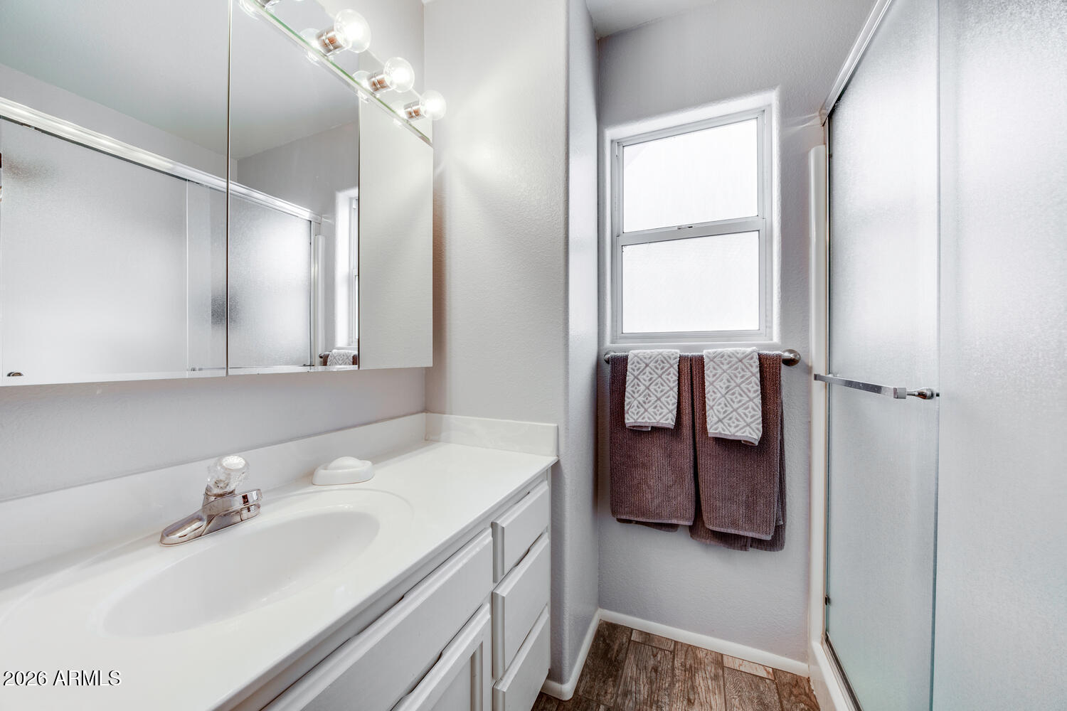 17200 West Bell Road, Unit 1260 Surprise, AZ 85374 - Photo 14 of 31 a bathroom with a sink and a mirror