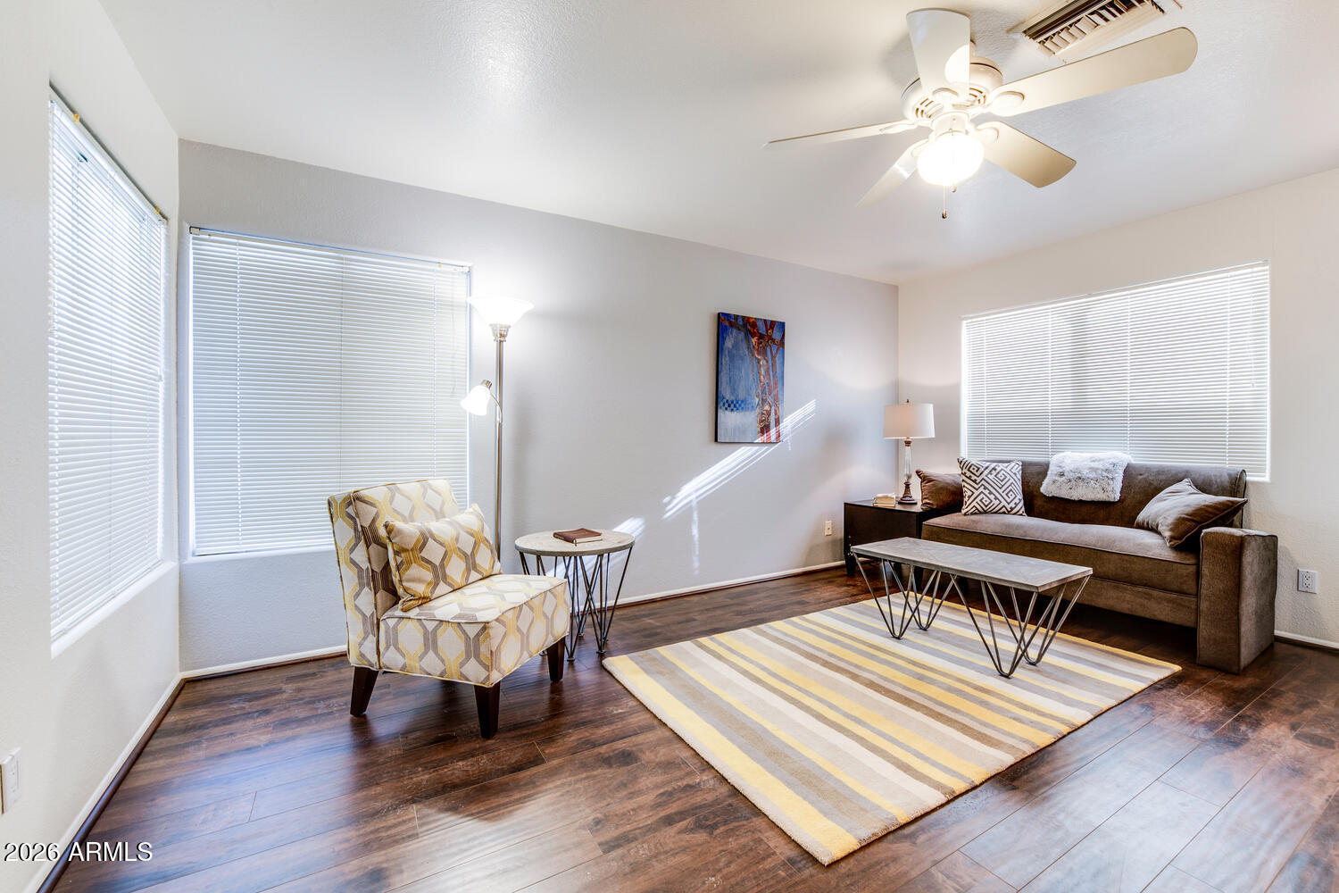 17200 West Bell Road, Unit 1260 Surprise, AZ 85374 - Photo 6 of 31 a living room with furniture a rug and a chandelier