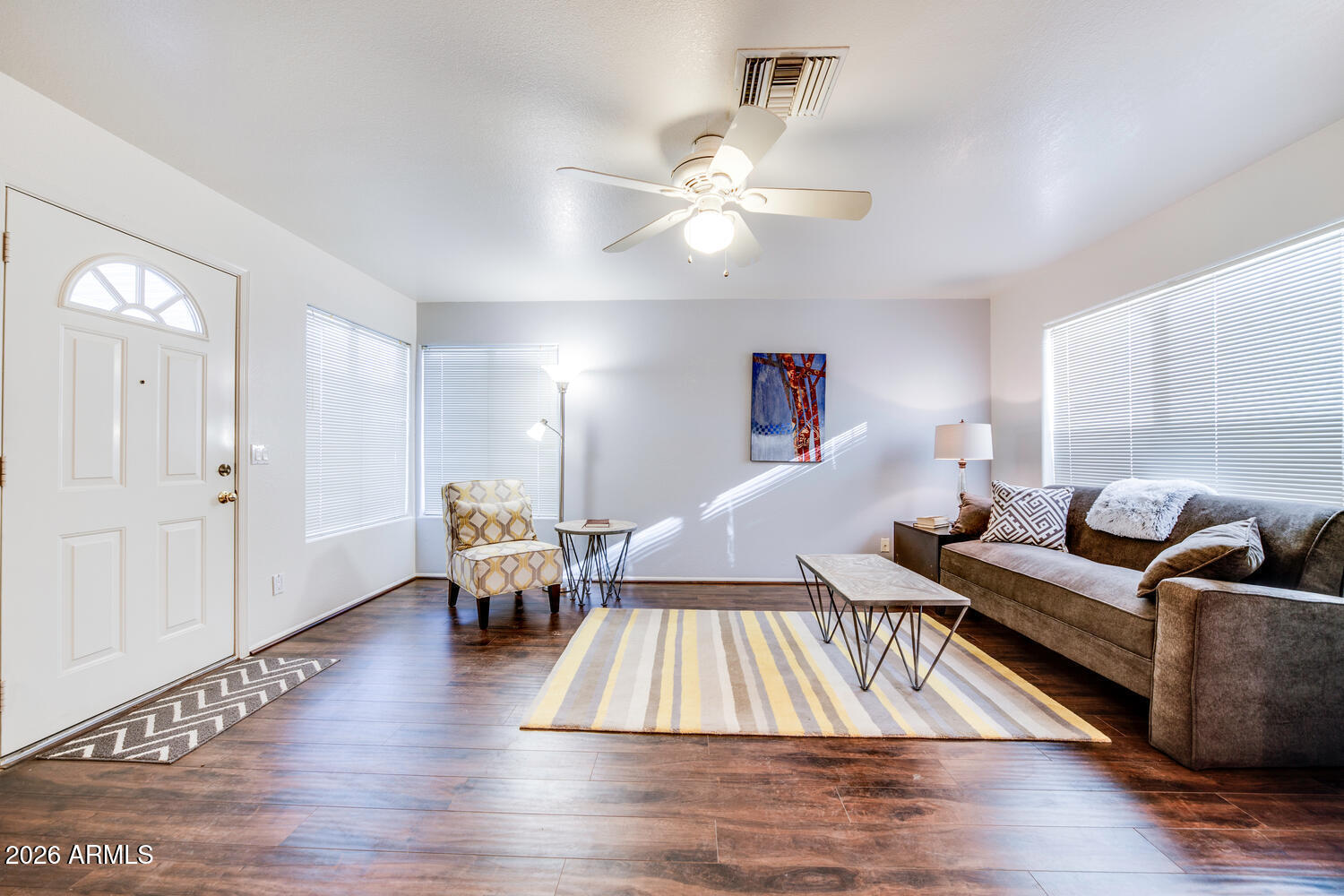 17200 West Bell Road, Unit 1260 Surprise, AZ 85374 - Photo 8 of 31 a living room with couches chairs and wooden floor