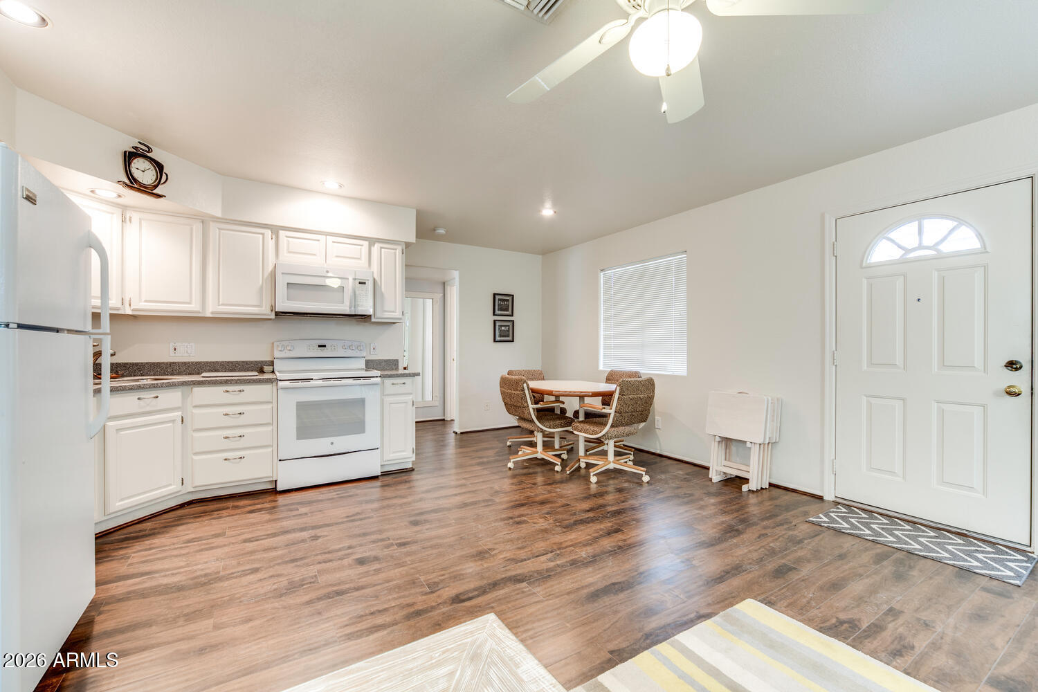 17200 West Bell Road, Unit 1260 Surprise, AZ 85374 - Photo 9 of 31 a kitchen with stainless steel appliances kitchen island granite countertop a stove a sink and a refrigerator