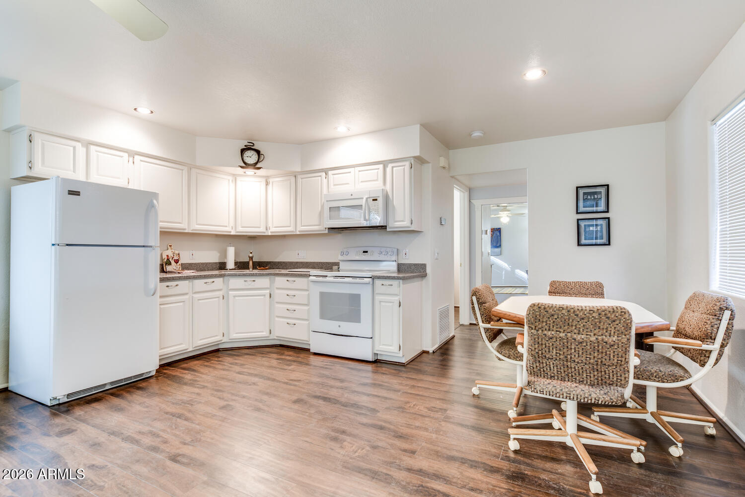 17200 West Bell Road, Unit 1260 Surprise, AZ 85374 - Photo 10 of 31 a kitchen with white cabinets and white appliances