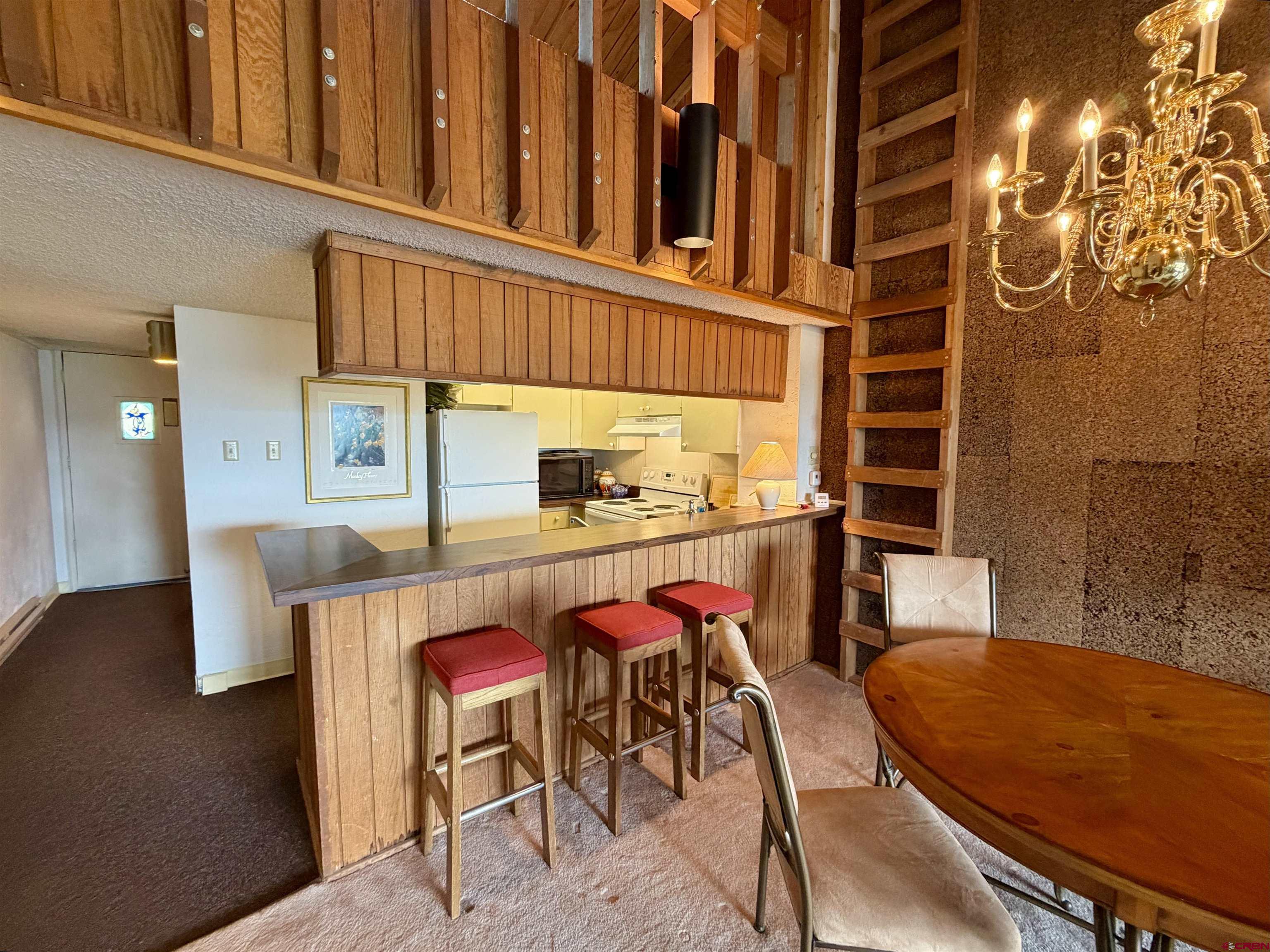 51 Whetstone Road, Unit 2306 Crested Butte, CO 81225 - Photo 15 of 44 a dining room with furniture and wooden floor