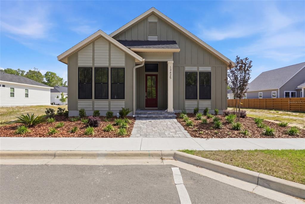 13425 Southwest 9th Road Newberry, FL 32669 - Photo 1 of 46 a front view of a house with garden