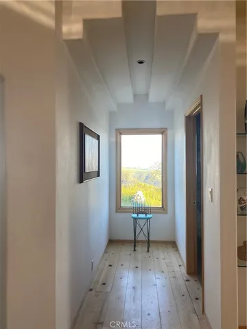 a large kitchen with stainless steel appliances a large counter top a stove a sink and a refrigerator