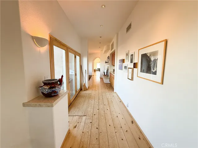 a view of a dining room with furniture large windows and wooden floor