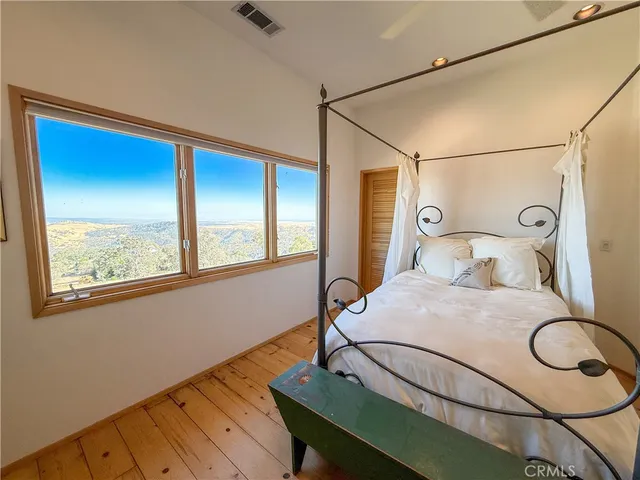 a large room with a large window and furniture