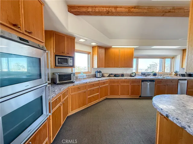 a bedroom with furniture and a large window