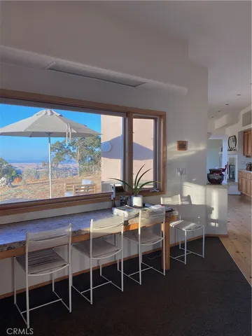 a living room with furniture and large window