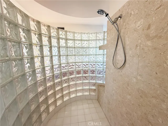 a living room with furniture a flat screen tv and floor to ceiling window