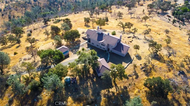 a living room with furniture kitchen view and a large window