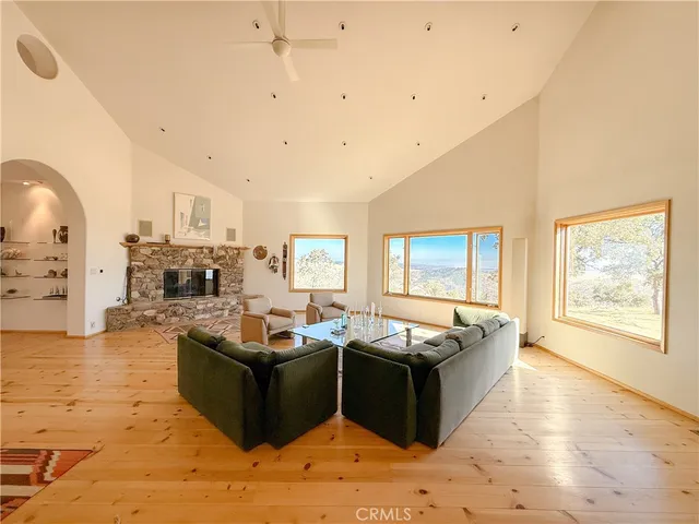 a living room with furniture fireplace and a window