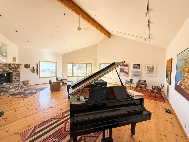 a view of living room with furniture and wooden floor