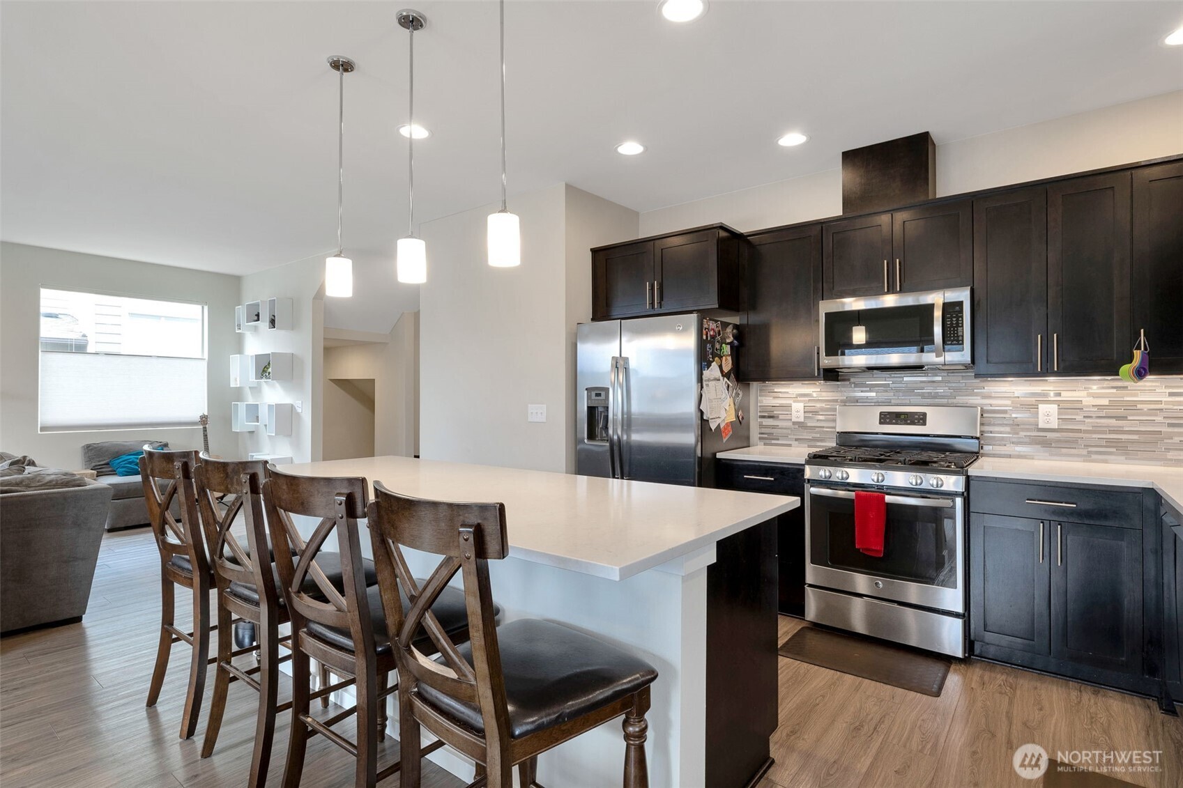 15817 Southeast 252 Place Covington, WA 98042 - Photo 11 of 31 a kitchen with kitchen island a cabinets dining table and chairs