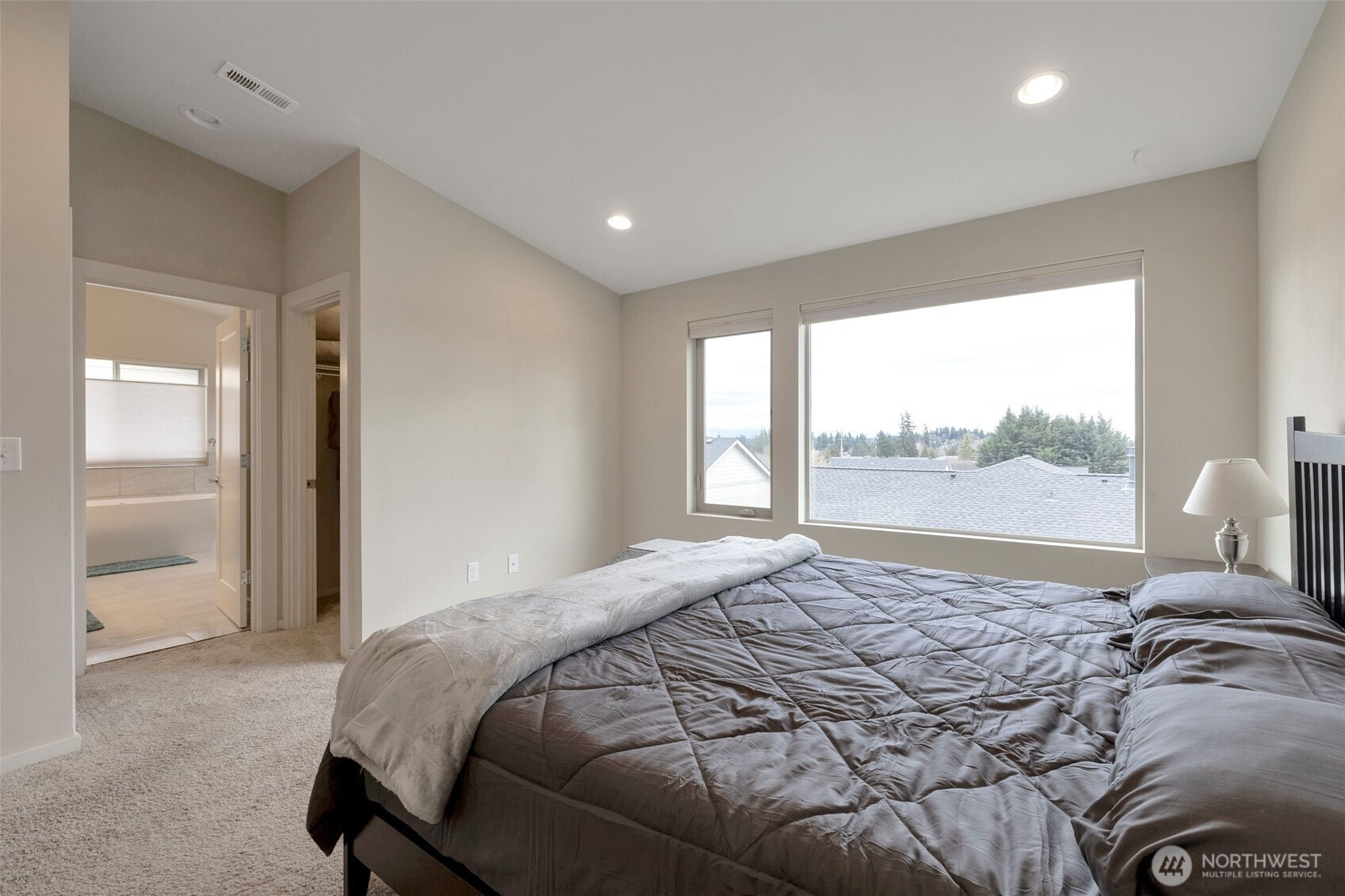 15817 Southeast 252 Place Covington, WA 98042 - Photo 16 of 31 a bedroom with a large bed and a large window