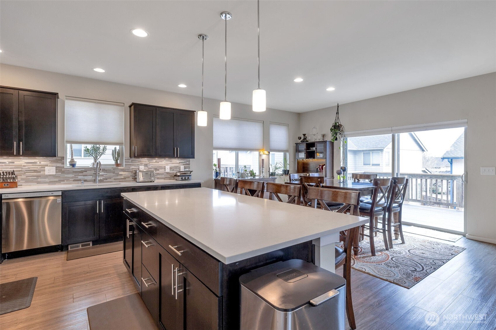15817 Southeast 252 Place Covington, WA 98042 - Photo 10 of 31 a kitchen with a dining table chairs and wooden floor