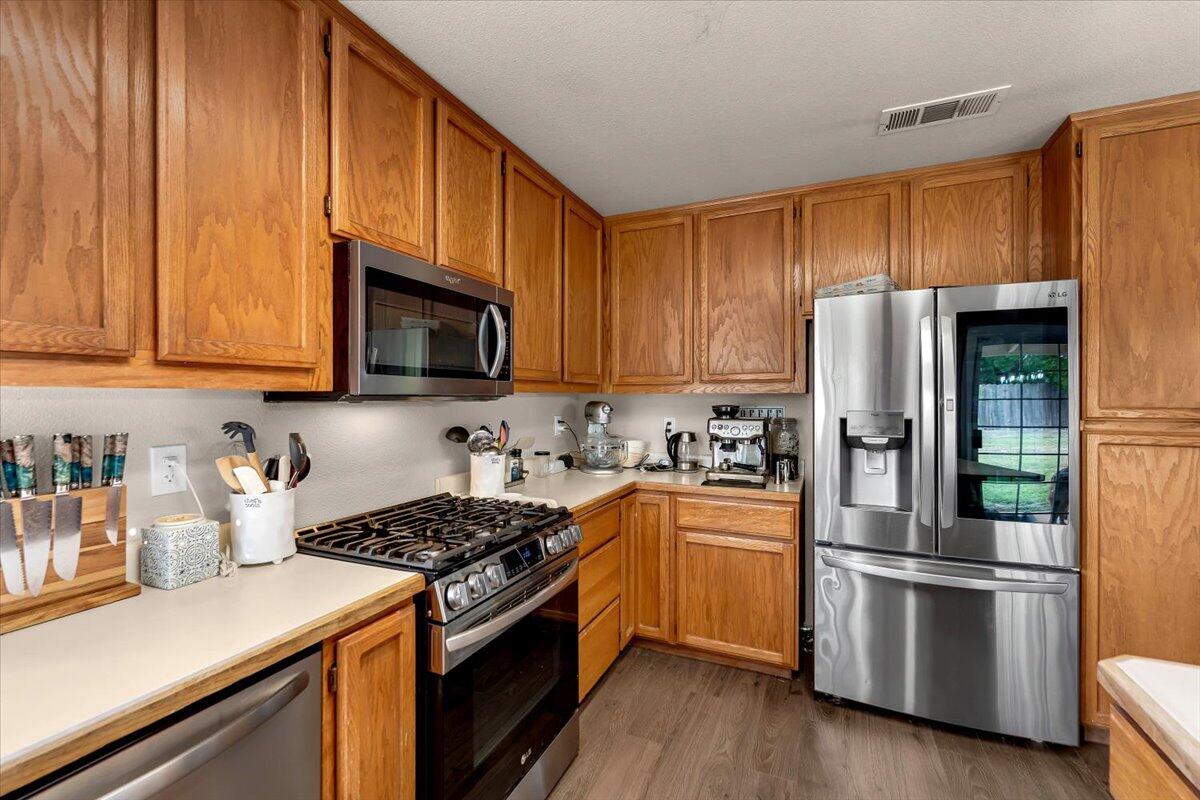1675 Hominy Way Redding, CA 96003 - Photo 13 of 38 a kitchen with a refrigerator stove and microwave