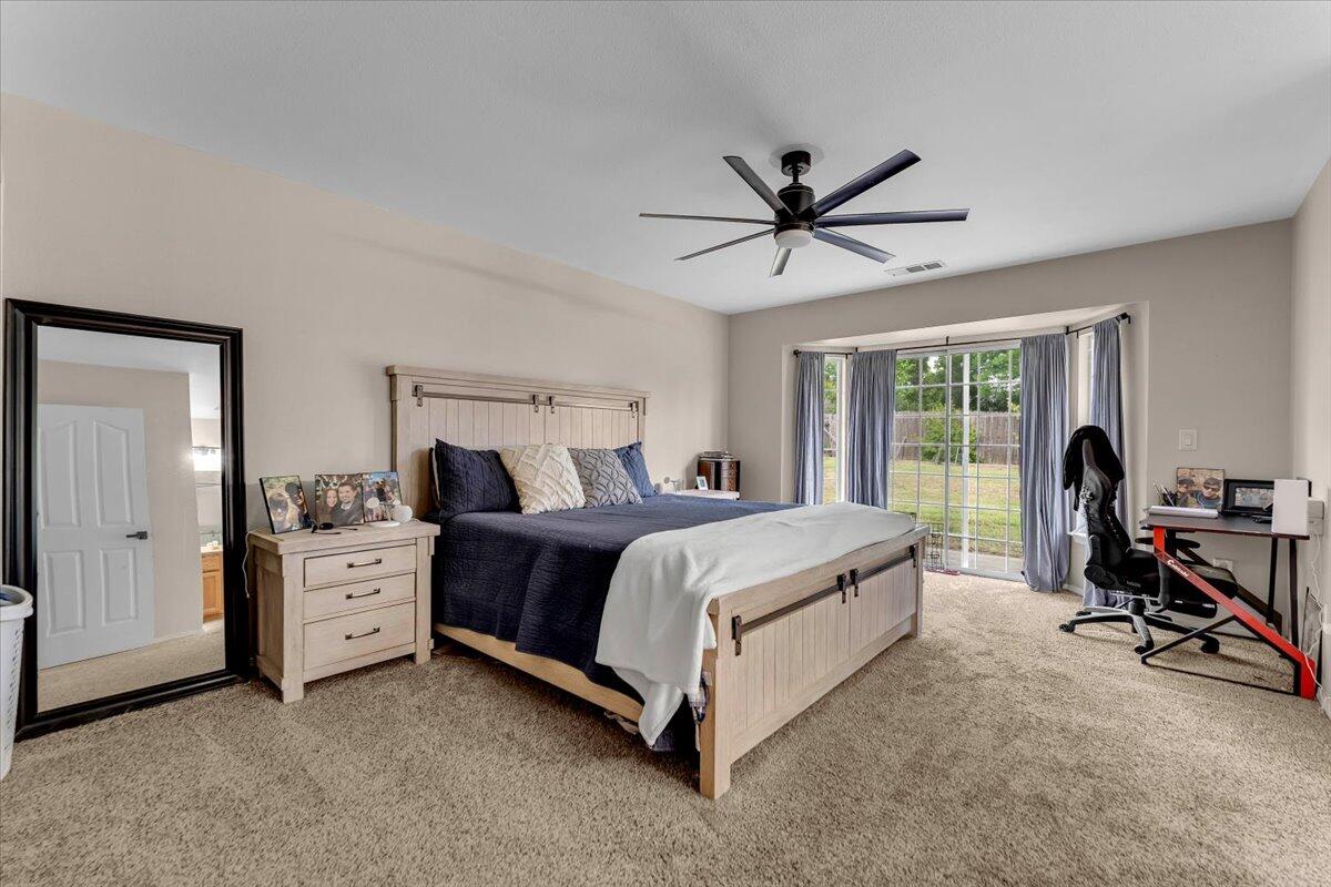 1675 Hominy Way Redding, CA 96003 - Photo 15 of 38 a bed room with a bed and a large window