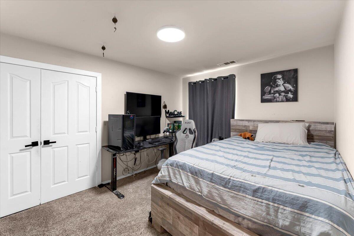 1675 Hominy Way Redding, CA 96003 - Photo 21 of 38 a bedroom with a bed and a flat screen tv