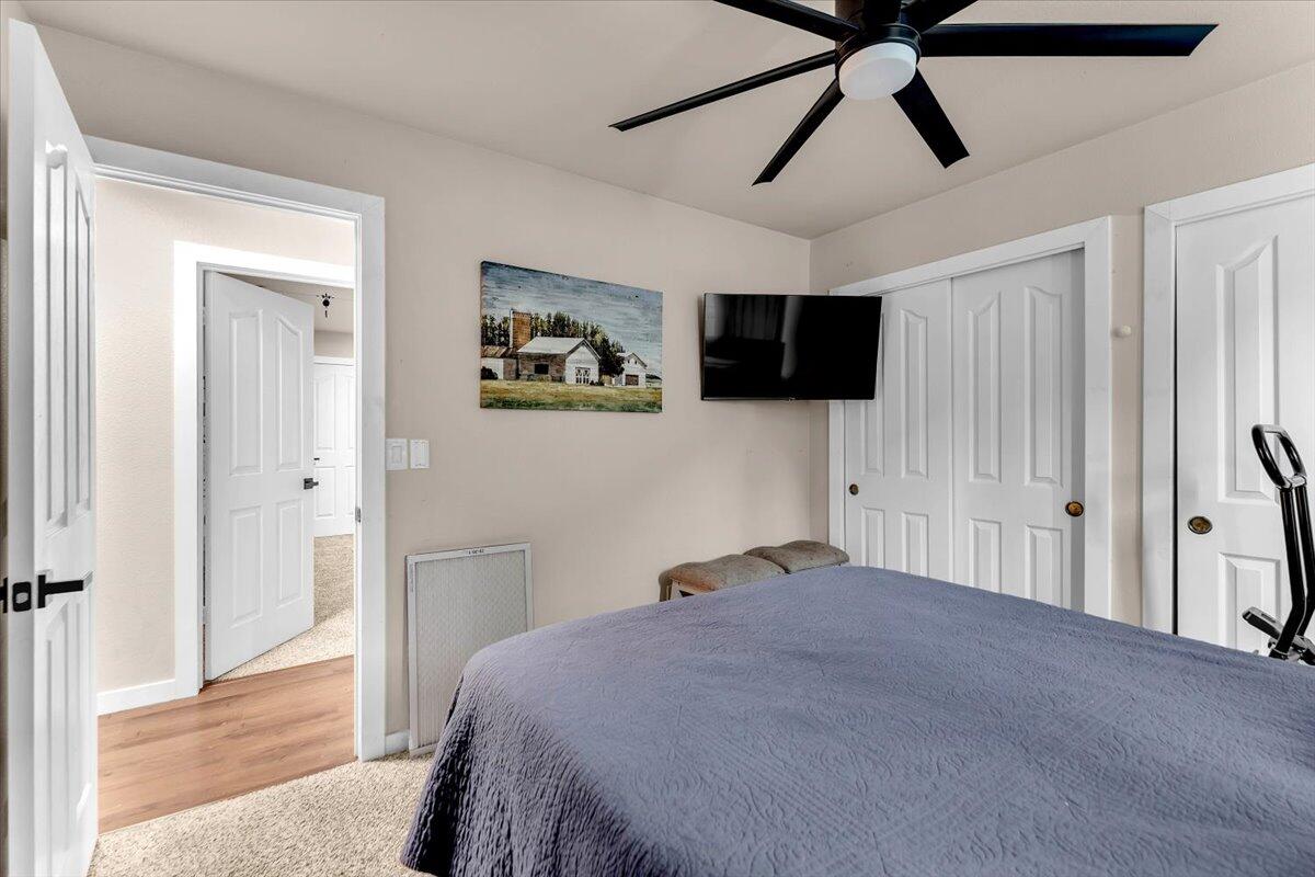1675 Hominy Way Redding, CA 96003 - Photo 24 of 38 a bedroom with a bed and a flat screen tv