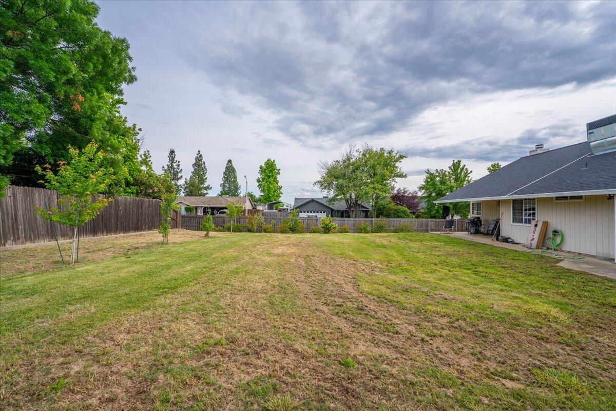 1675 Hominy Way Redding, CA 96003 - Photo 33 of 38 a view of a house with a yard