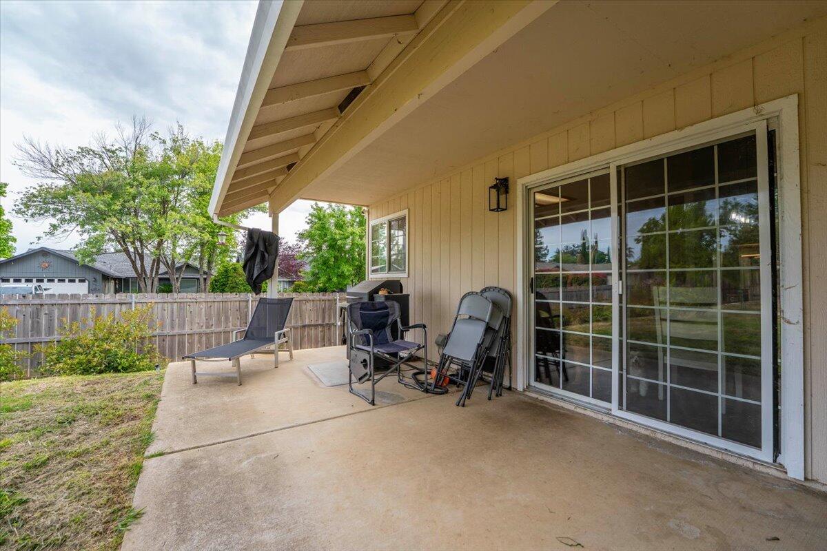 1675 Hominy Way Redding, CA 96003 - Photo 34 of 38 a view of a patio with table and chairs and potted plants