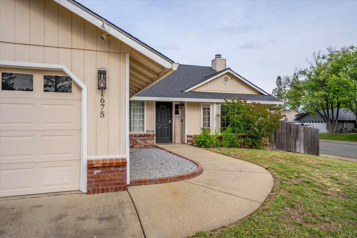 1675 Hominy Way Redding, CA 96003 - Photo 35 of 38 a front view of a house with garden