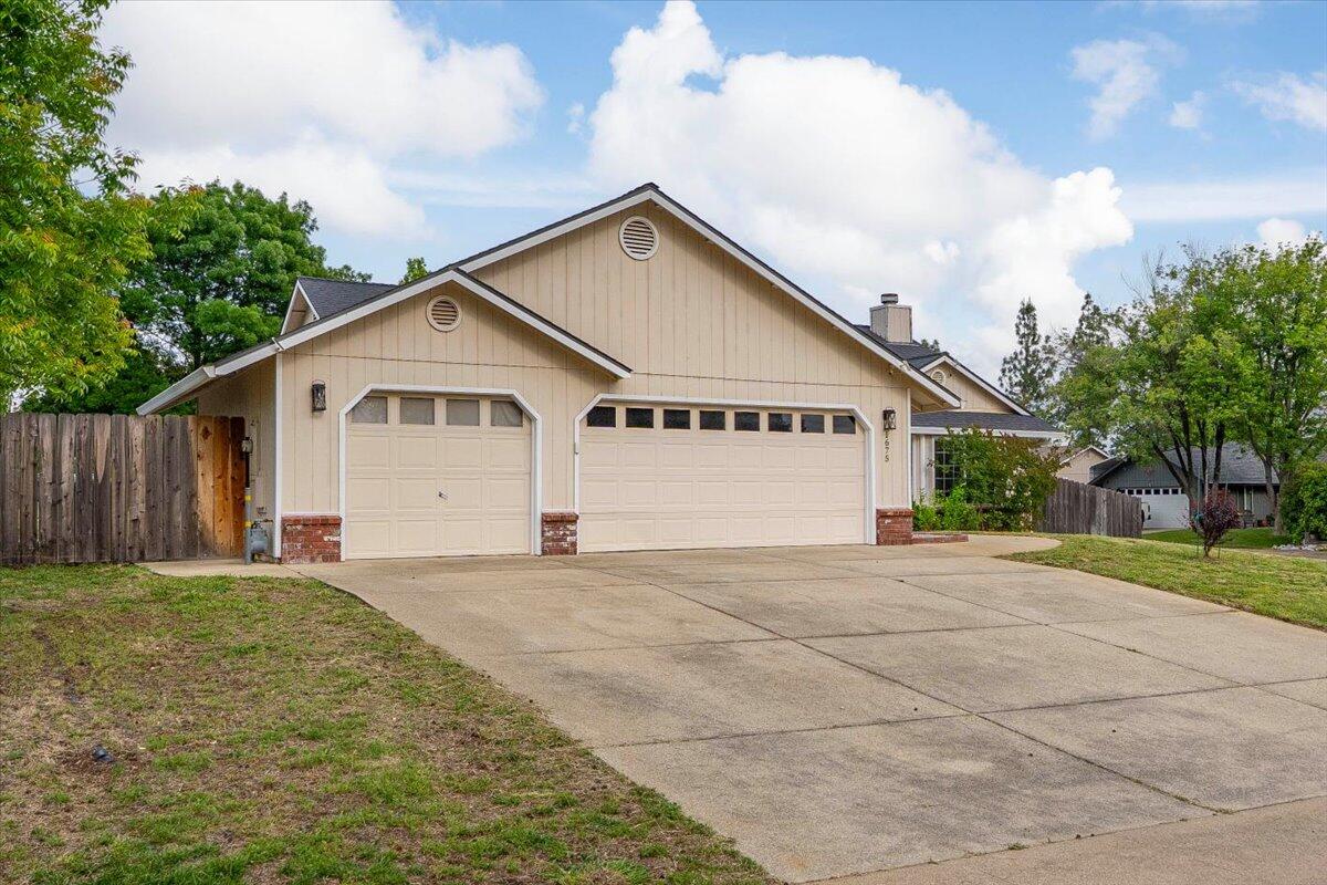 1675 Hominy Way Redding, CA 96003 - Photo 36 of 38 a view of a house with a yard and large trees