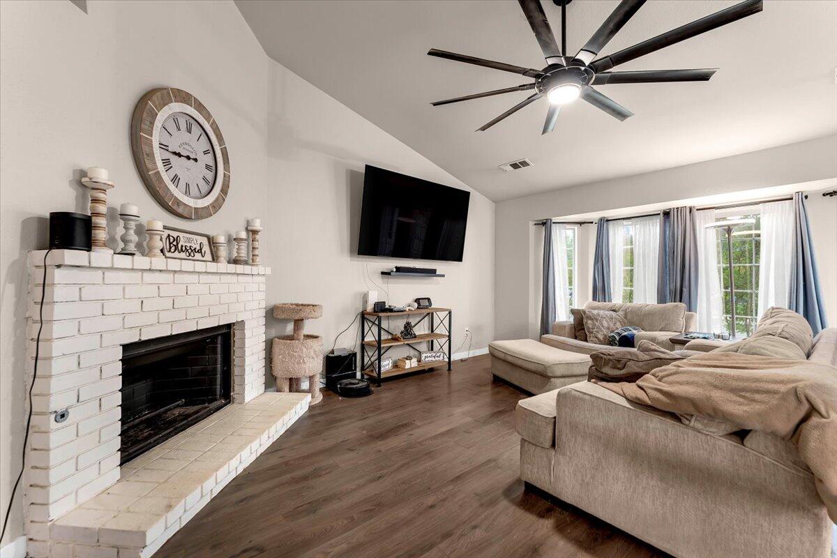 1675 Hominy Way Redding, CA 96003 - Photo 4 of 38 a living room with furniture a fireplace and a flat screen tv