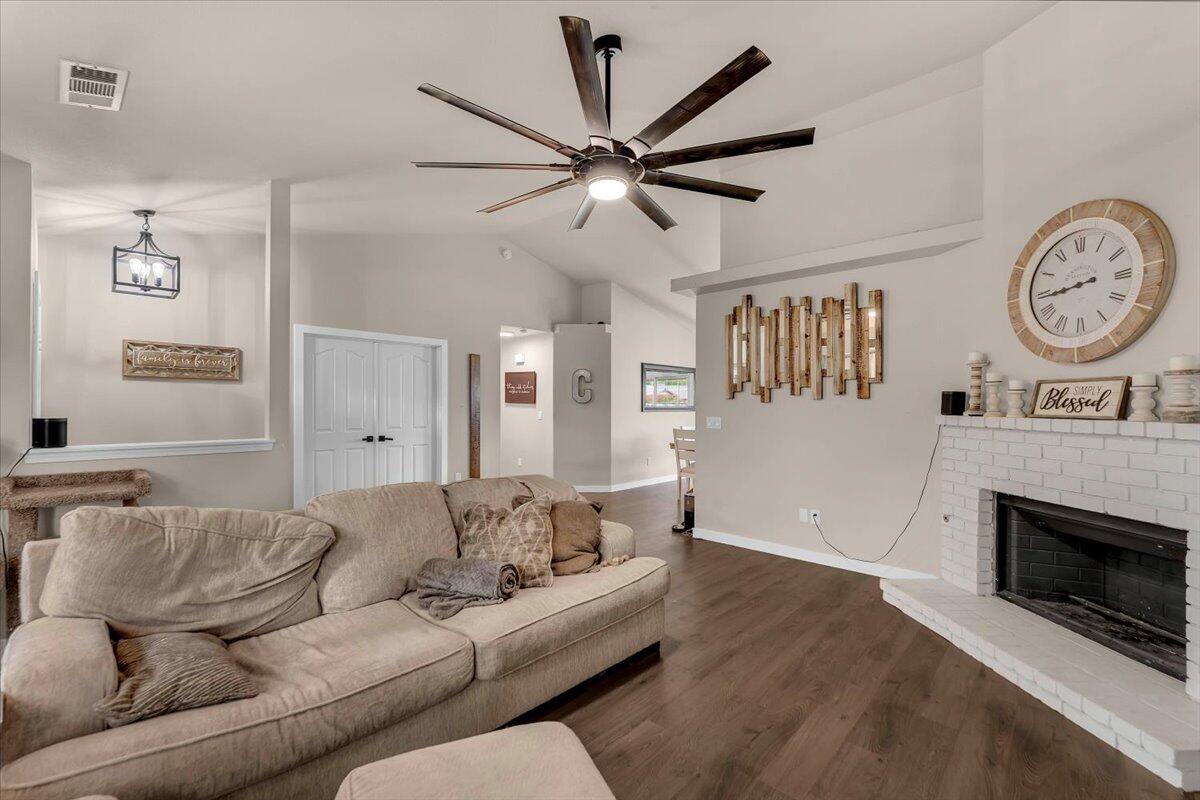 1675 Hominy Way Redding, CA 96003 - Photo 6 of 38 a living room with furniture a clock and a fireplace