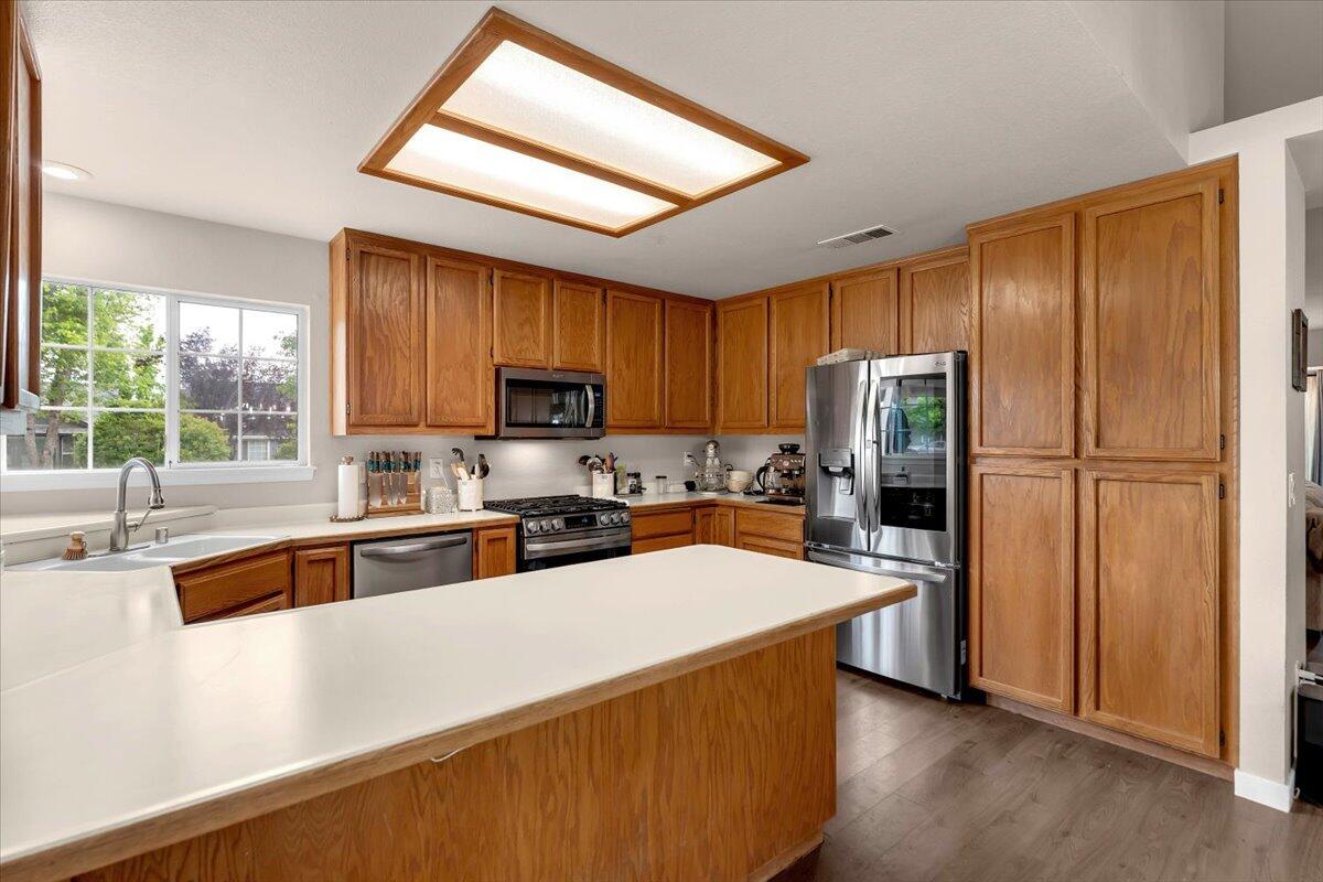 1675 Hominy Way Redding, CA 96003 - Photo 10 of 38 a kitchen with stainless steel appliances a refrigerator sink and microwave