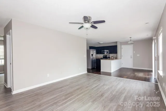 a view of a kitchen with a sink and wooden floor