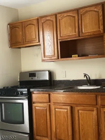 a kitchen with stainless steel appliances granite countertop a sink stove and microwave