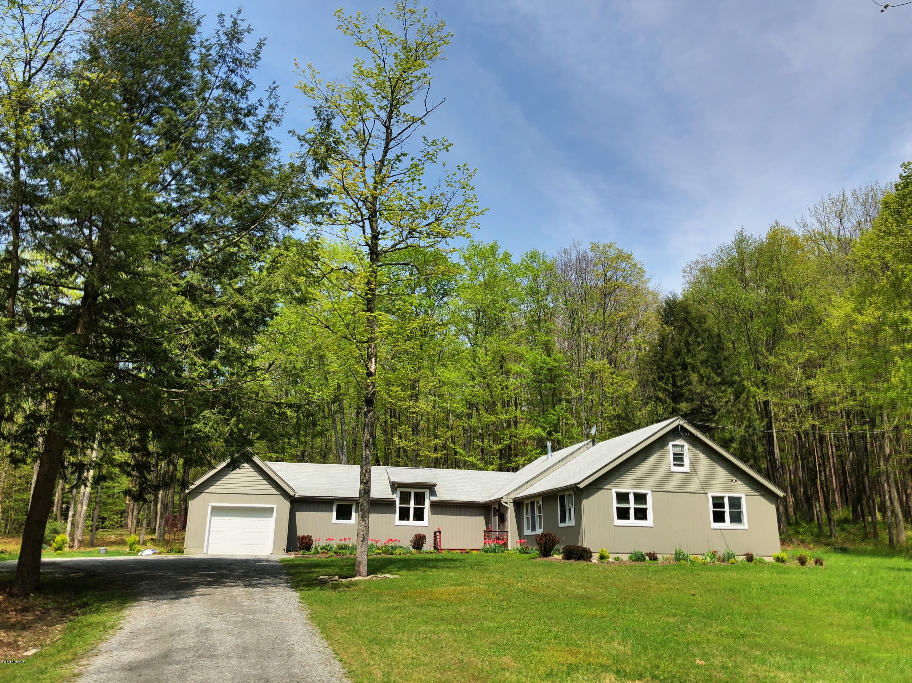 131 Tyringham Road Otis, MA 01253 - Photo 3 of 46 a front view of a house with garden