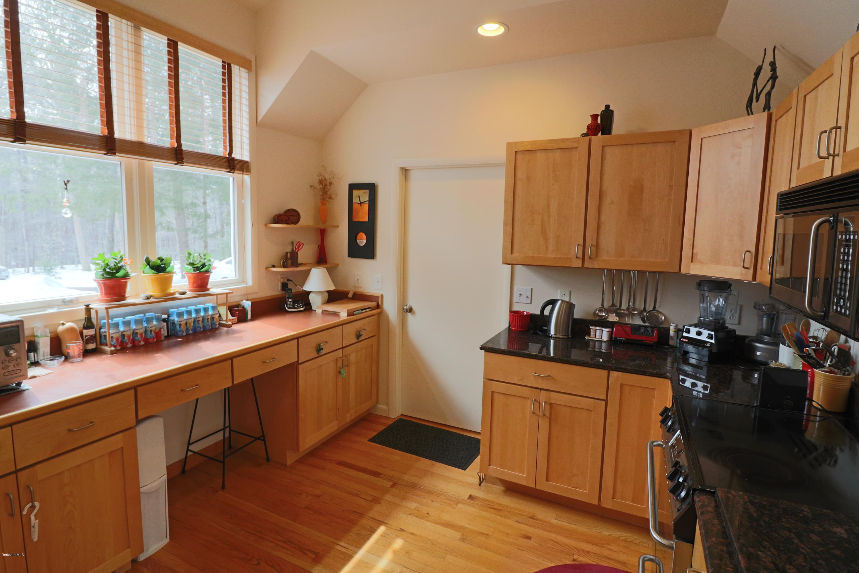 131 Tyringham Road Otis, MA 01253 - Photo 23 of 46 a kitchen with stainless steel appliances a sink a stove a refrigerator cabinets and a window