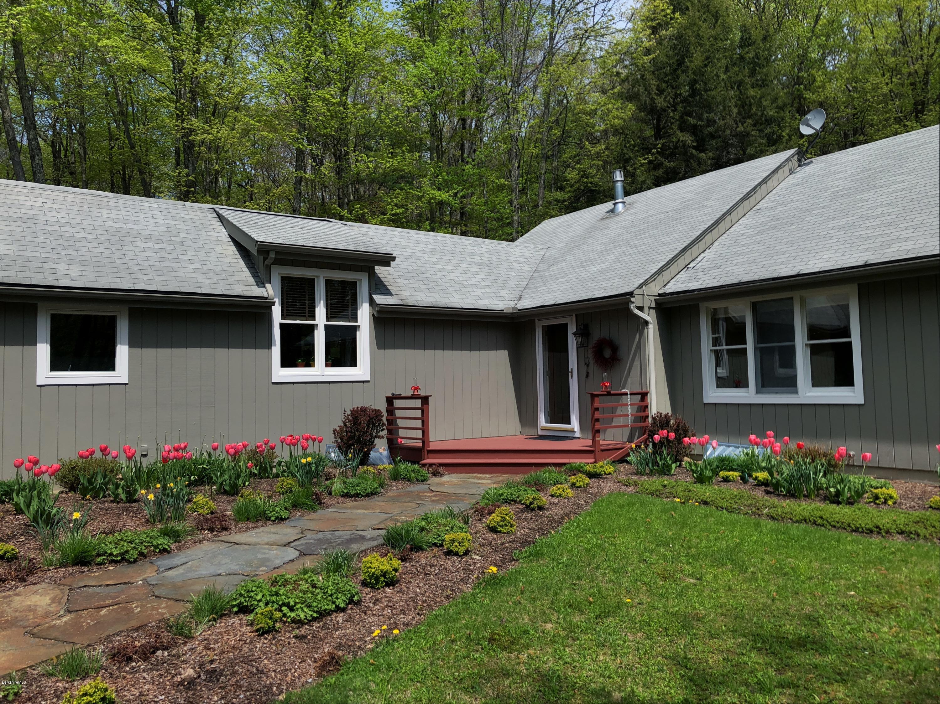 131 Tyringham Road Otis, MA 01253 - Photo 5 of 46 a front view of a house with garden