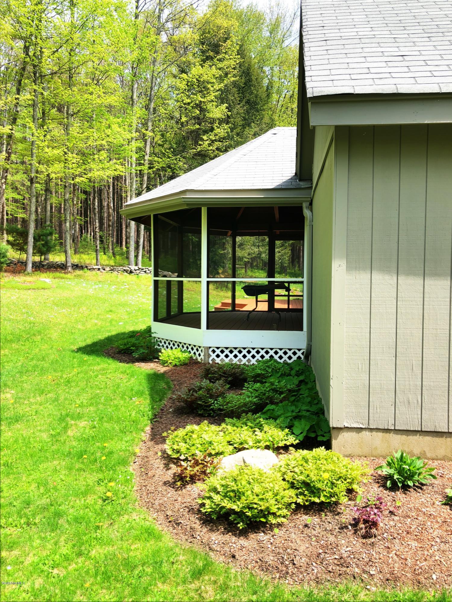 131 Tyringham Road Otis, MA 01253 - Photo 10 of 46 a front view of a house with garden